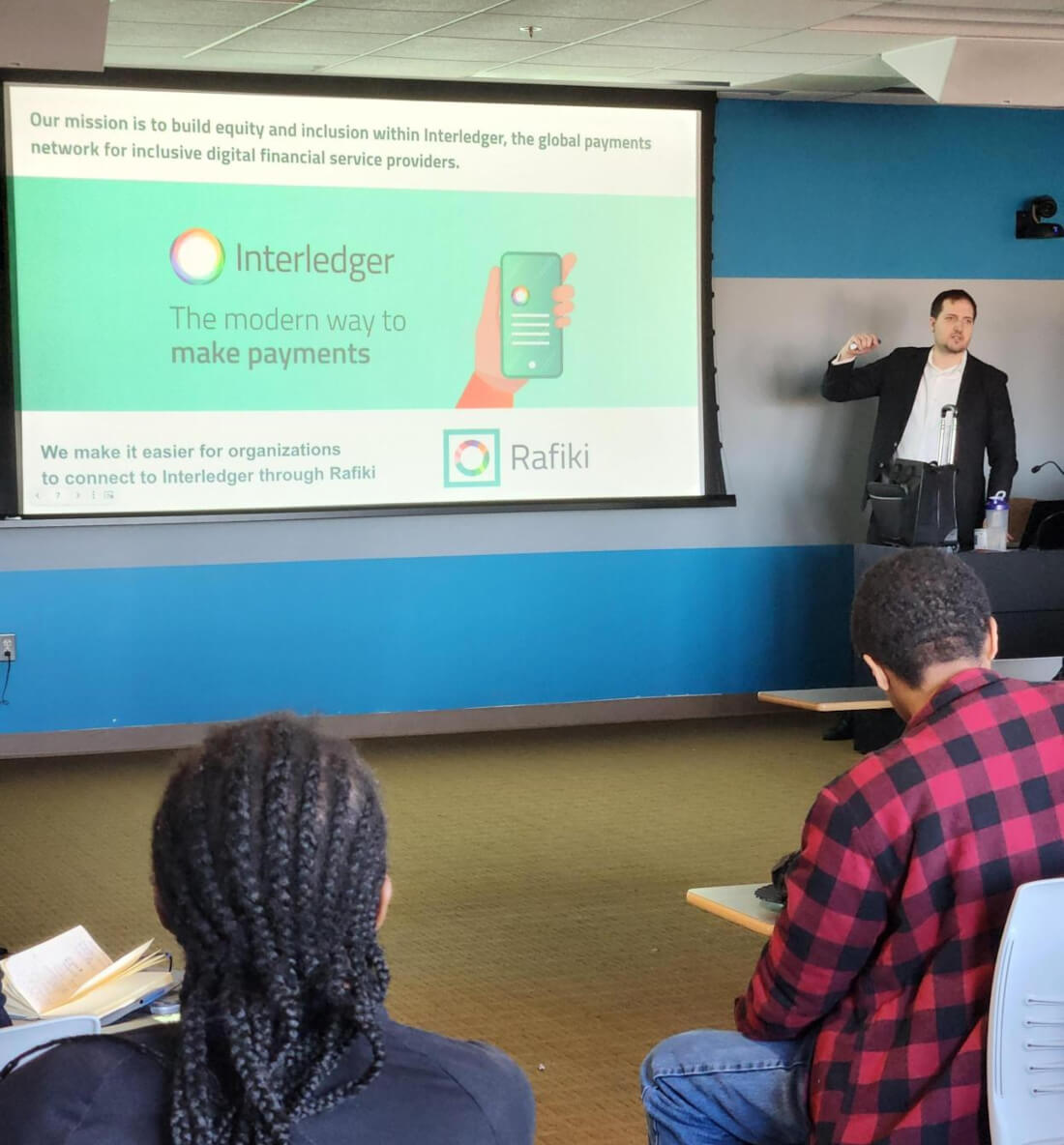 Dr. Andrew Mangle delivering a presentation on Interledger to a classroom of university students.