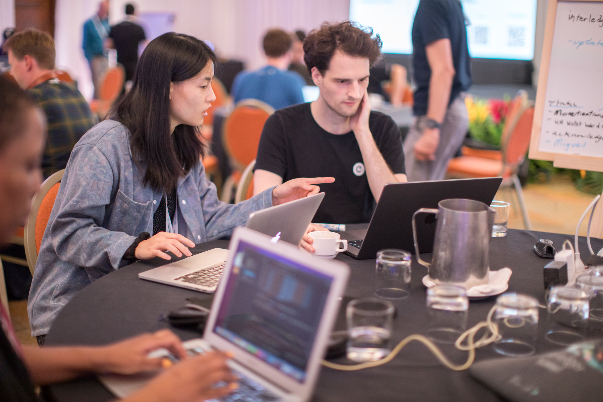 People discuss their solution at an Interledger Hackathon